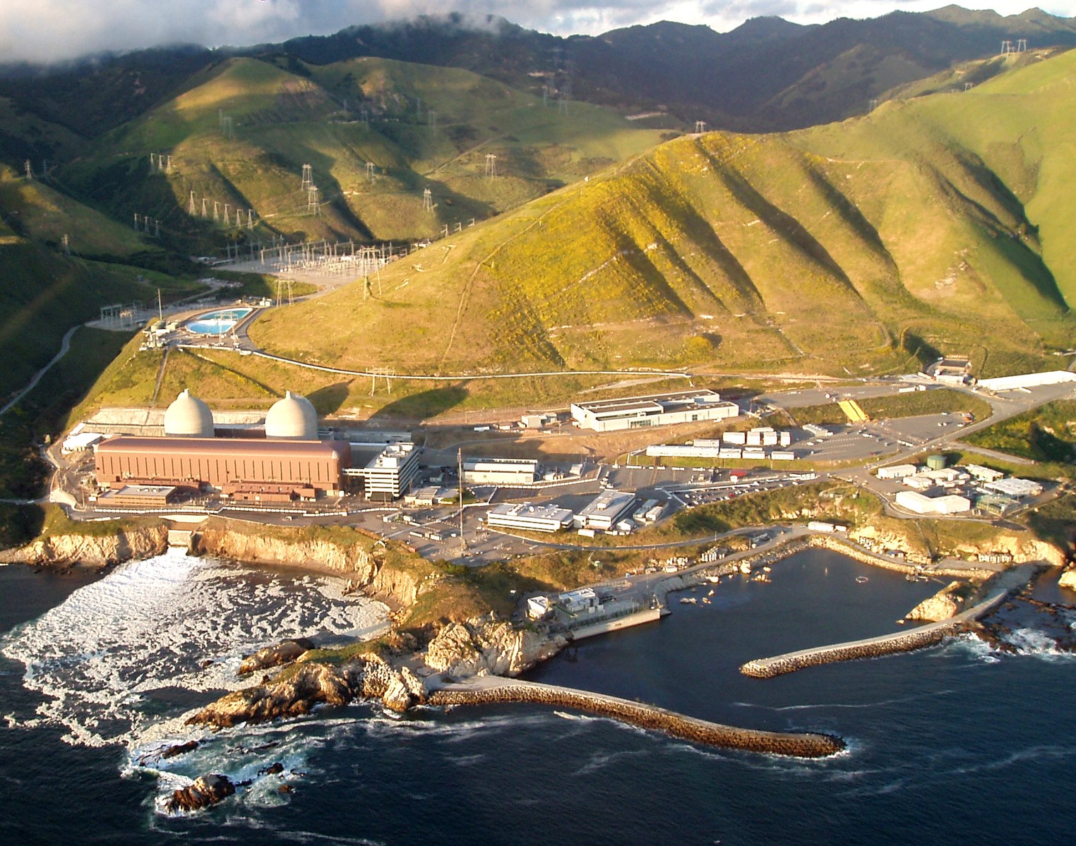 Aerial view of the Diablo Canyon nuclear plant on the California coast below golden hills