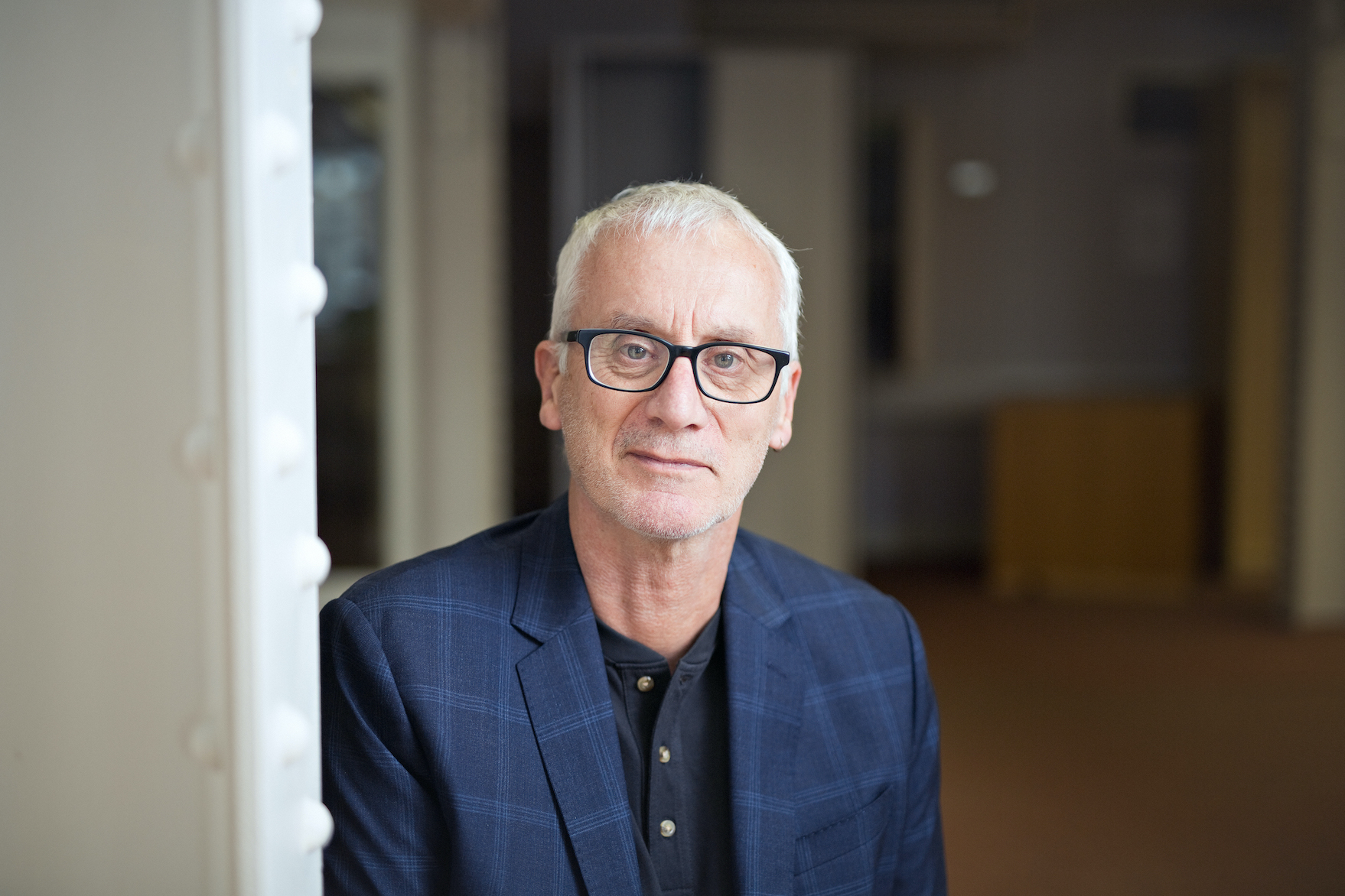 Portrait of Huw Price in a dark blue jacket