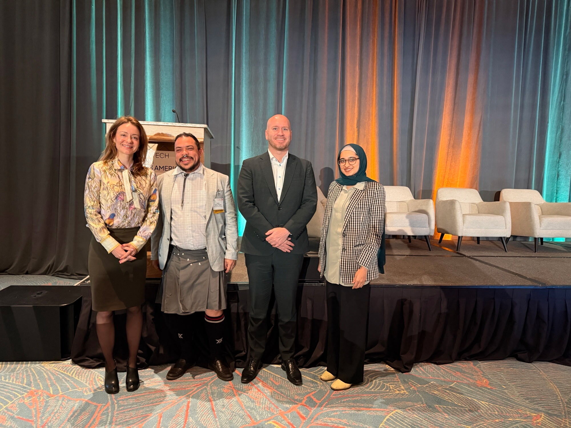 Zainab Gilani, Guido Nunez-Mujica, Erik Funkhouser and Dr. Leslie Dewan standing together in front of the stage at Cleantech Forum North America