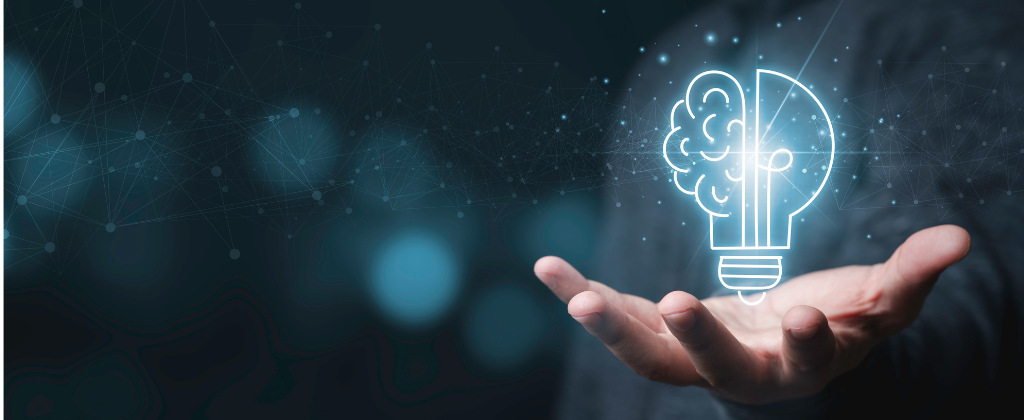 An open hand beneath a glowing outline of a light bulb whose left half is drawn as a brain, over a dark field of connected points