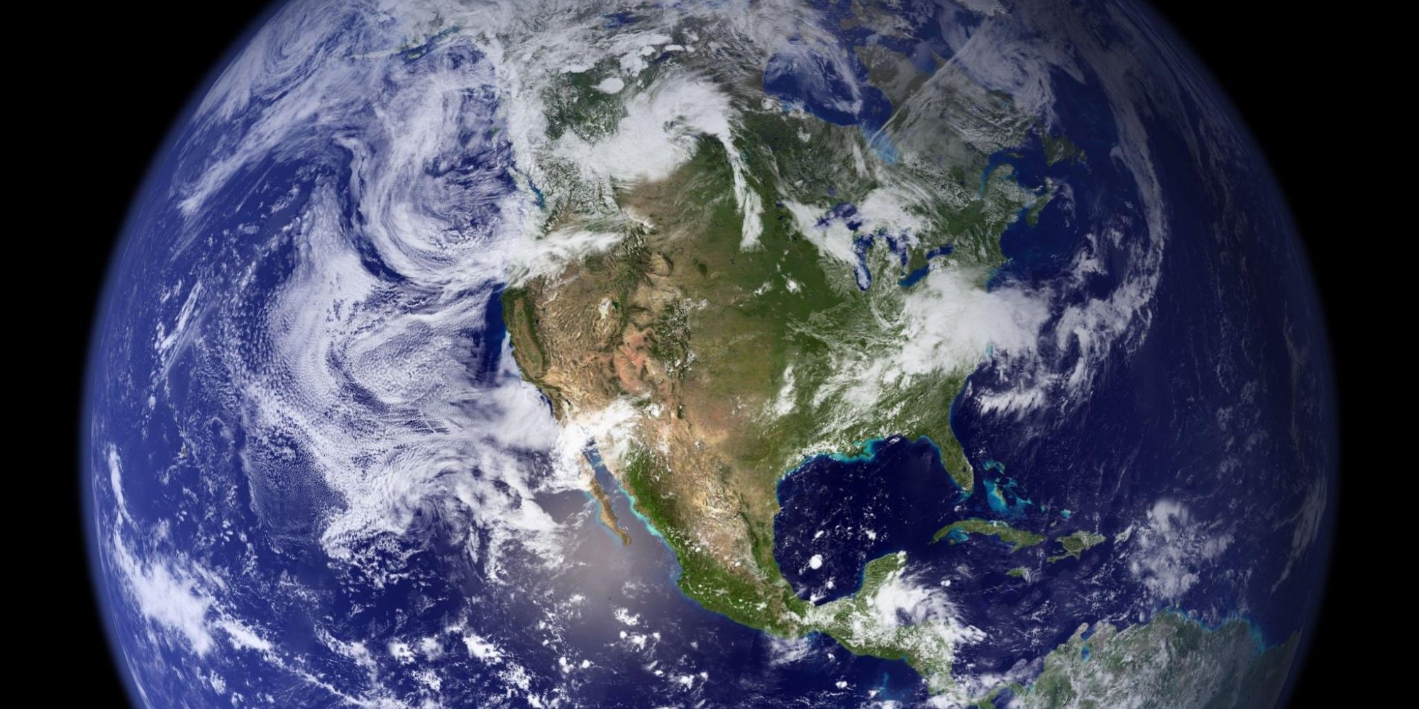 Satellite view of Earth showing North America, the Pacific and swirling cloud systems against black space