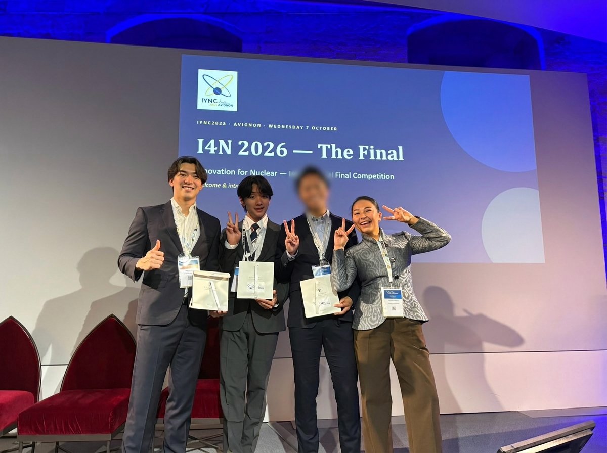 The four members of Japan YGN smiling on stage with their prize bags in front of the I4N 2026 final screen