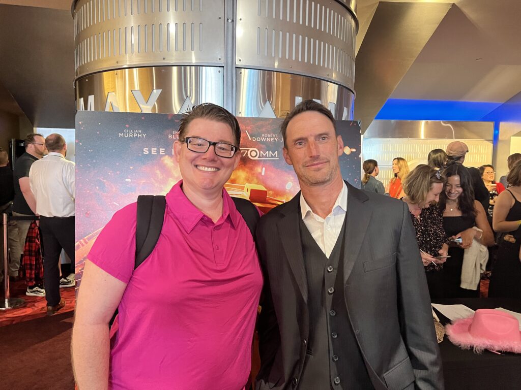 Charles Oppenheimer standing with Micah Brown at the cinema