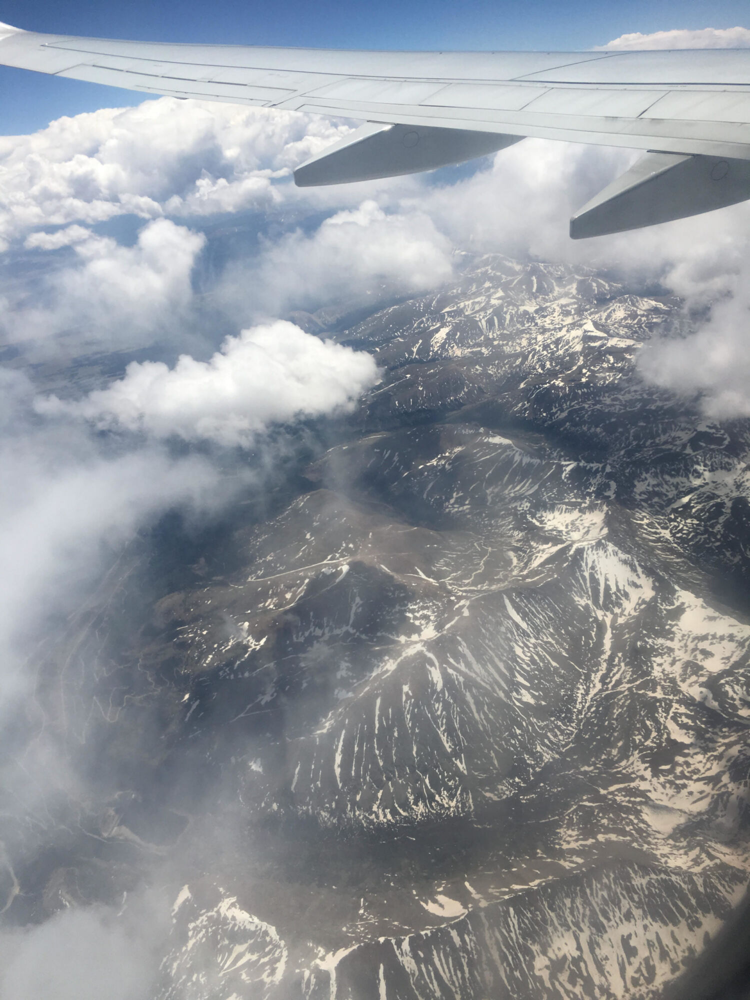 A mountain ridge rising above a layer of cloud